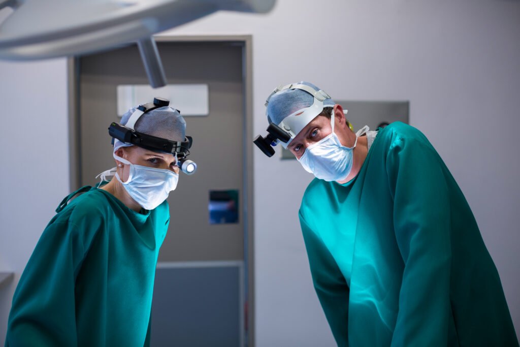 surgeons wearing surgical loupes while performing operation in operation theater
